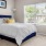 a bedroom with a bed and lamps