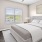 a bedroom with a bed and a fan
